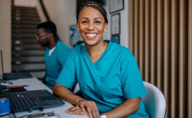Medical assistant sitting at a desk