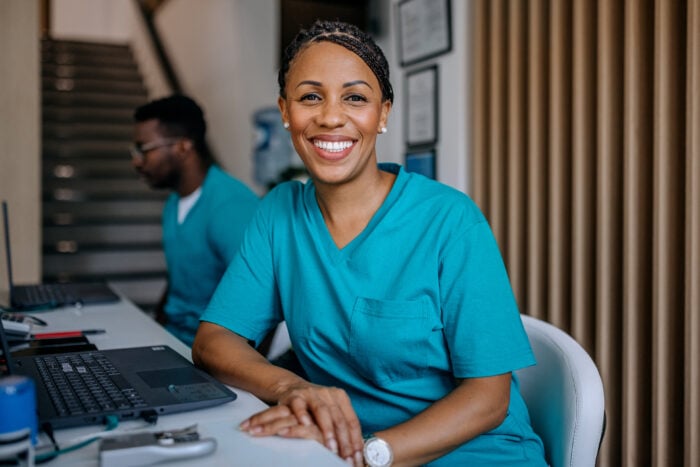 Medical assistant sitting at a desk