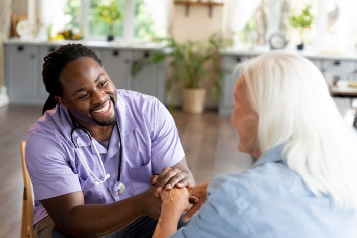 Medical assistant gaining clinical experience with senior patient