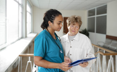 Medical assistant in an externship works with a patient